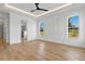 Bedroom showcasing wood floors, white walls, tray ceilings, recessed lighting, and three large windows at 55 Harvest View Way, Franklinton, NC 27525
