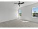 Bedroom featuring plush carpet, ceiling fan and natural light with windows at 55 Harvest View Way, Franklinton, NC 27525