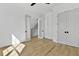 Spacious bedroom featuring hardwood floors, a ceiling fan, closet space, and bright, white walls at 55 Harvest View Way, Franklinton, NC 27525