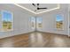 Spacious bedroom with large windows, hardwood floors, tray ceiling, recessed lighting, and neutral walls at 55 Harvest View Way, Franklinton, NC 27525