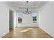Bright dining room featuring hardwood floors, a modern chandelier, and two windows offering plenty of natural light at 55 Harvest View Way, Franklinton, NC 27525
