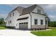 Spacious two-story home with a gray garage door, white siding, and well-maintained landscaping at 55 Harvest View Way, Franklinton, NC 27525