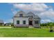 Charming two-story home showcasing a lush green lawn and classic architectural details at 55 Harvest View Way, Franklinton, NC 27525