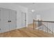 Hallway featuring wood floors, white walls, crown molding, and access to multiple rooms with doors at 55 Harvest View Way, Franklinton, NC 27525