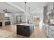 Spacious kitchen features an island with a black base and granite counters, plus stainless appliances at 55 Harvest View Way, Franklinton, NC 27525