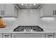 Close up of the gas range with granite counters and white herringbone backsplash at 55 Harvest View Way, Franklinton, NC 27525