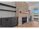 Stone fireplace, built-ins, and access to the balcony can be seen in this living room at 55 Harvest View Way, Franklinton, NC 27525
