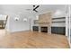 Inviting living room offers a stone fireplace, built-in shelves, hardwood floors, recessed lighting, and access to a staircase at 55 Harvest View Way, Franklinton, NC 27525