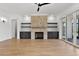 Comfortable living room features a cozy stone fireplace, built-in shelving, recessed lights, and sliding doors at 55 Harvest View Way, Franklinton, NC 27525