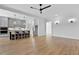 Open concept living area with a kitchen island and eat in seating with contemporary light fixtures and grey cabinetry at 55 Harvest View Way, Franklinton, NC 27525