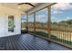 Screened-in porch with wood floors, ceiling fan, and view of the trees at 55 Harvest View Way, Franklinton, NC 27525