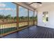 Open screened-in porch with wood floors, ceiling fan, and view of the trees at 55 Harvest View Way, Franklinton, NC 27525