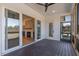 Screened-in porch with wood floors, ceiling fan, and stone fireplace at 55 Harvest View Way, Franklinton, NC 27525