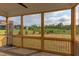 The screened porch gives great views of the backyard with lush greenery and blue skies at 55 Harvest View Way, Franklinton, NC 27525