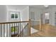 Bright foyer with staircase, hardwood floors, black railings, and light fixture at 55 Harvest View Way, Franklinton, NC 27525