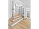 Detail shot of the hidden storage next to a staircase, featuring hardwood steps and access to a hallway at 55 Harvest View Way, Franklinton, NC 27525