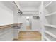 Walk-in closet features custom shelving and wood floors, offering ample storage and organization at 55 Harvest View Way, Franklinton, NC 27525