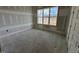 Well-lit bedroom with large window and unfinished drywall at 6052 Scalybark, Durham, NC 27712