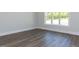 Bedroom with hardwood floors, natural light, and a double window at 6052 Scalybark Rd, Durham, NC 27712