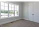 Neutral bedroom featuring natural light and an extra large window with nice views at 6052 Scalybark Rd, Durham, NC 27712