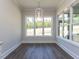 Glass enclosed shower features subway tile, a built-in bench and a small window at 6052 Scalybark Rd, Durham, NC 27712