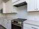 Bright kitchen with stainless steel appliances and subway tile backsplash at 6052 Scalybark Rd, Durham, NC 27712