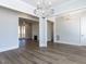 Open-concept living room with hardwood floors and modern chandelier at 6052 Scalybark Rd, Durham, NC 27712