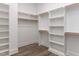 Spacious walk-in closet with custom shelving and wooden rods for ample storage at 6052 Scalybark Rd, Durham, NC 27712