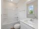 Bright bathroom featuring a tub-shower combination, single vanity, and tile flooring at 117 Shelby Meadow Ln, Angier, NC 27501