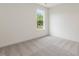 Cozy bedroom with plush carpeting and a large window with natural light at 117 Shelby Meadow Ln, Angier, NC 27501