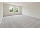 Large, carpeted bedroom with natural light streaming through two windows, creating a serene atmosphere at 117 Shelby Meadow Ln, Angier, NC 27501
