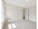 Bedroom with walk-in closet and doorway to another room with carpet flooring at 117 Shelby Meadow Ln, Angier, NC 27501