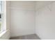 A walk-in closet with neutral carpet, shelving, and a view from the window at 117 Shelby Meadow Ln, Angier, NC 27501