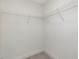Walk-in closet with white wire shelving for organization at 117 Shelby Meadow Ln, Angier, NC 27501