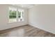 Bright dining room featuring wood-look flooring, large windows, and neutral wall color at 117 Shelby Meadow Ln, Angier, NC 27501