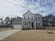 Charming two-story home with gray siding, white trim, covered porch, and a spacious front yard at 117 Shelby Meadow Ln, Angier, NC 27501