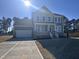 Beautiful two-story home featuring a two-car garage, landscaped yard, and inviting front porch at 117 Shelby Meadow Ln, Angier, NC 27501