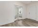 Bright flex room with wood-look flooring, white trim, and glass paneled french doors at 117 Shelby Meadow Ln, Angier, NC 27501