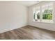 Versatile flex space with wood-look flooring, natural light, and clean white walls at 117 Shelby Meadow Ln, Angier, NC 27501