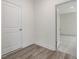Hallway with white doors and trim leads to a carpeted room at 117 Shelby Meadow Ln, Angier, NC 27501