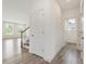 Hallway with white trim and doors leads to the living area with stair access at 117 Shelby Meadow Ln, Angier, NC 27501