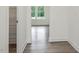 Bright hallway boasts wood floors and flows into a room with light-filled windows at 117 Shelby Meadow Ln, Angier, NC 27501