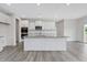 Bright kitchen featuring an island with granite countertops and white cabinets at 117 Shelby Meadow Ln, Angier, NC 27501