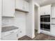 Pantry area with stainless double oven and white cabinets in modern kitchen at 117 Shelby Meadow Ln, Angier, NC 27501