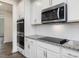 Modern kitchen appliances including built-in microwave and double oven set in white cabinetry at 117 Shelby Meadow Ln, Angier, NC 27501