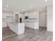 Modern kitchen with granite countertops, stainless appliances, and wood floors at 117 Shelby Meadow Ln, Angier, NC 27501