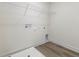 Clean laundry room with wood-look flooring and utility connections at 117 Shelby Meadow Ln, Angier, NC 27501