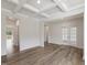 Bright living room featuring coffered ceilings, wood floors, and glass paneled doors to the outdoors at 117 Shelby Meadow Ln, Angier, NC 27501
