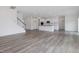 View of the open floor plan combining the kitchen and living room with stair access at 117 Shelby Meadow Ln, Angier, NC 27501