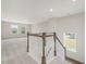 Staircase leading to a carpeted upper-level space, with a view of trees through the windows at 117 Shelby Meadow Ln, Angier, NC 27501